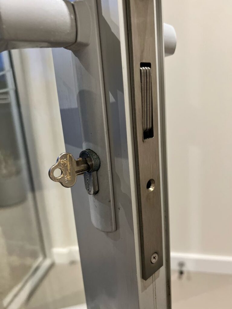 Close-up of a door lock with a broken key inside it.